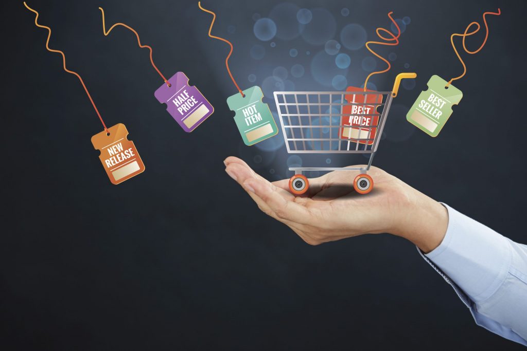 hand holding a little shopping cart representing ecommerce