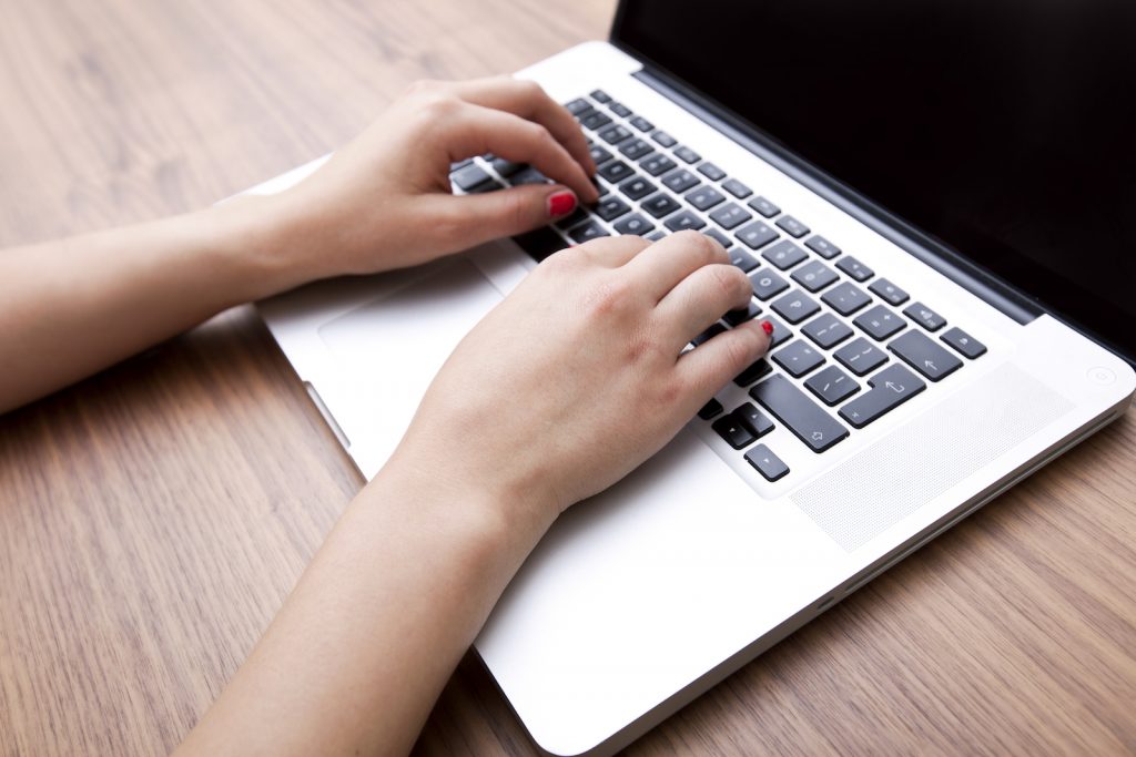 lady writing content for her business website on a laptop